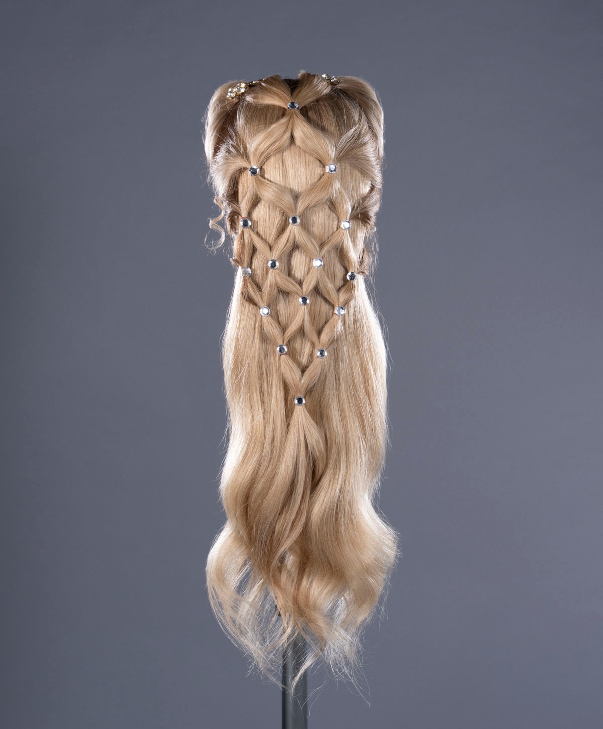 A blonde wig with lattice-inspired braids used on Margot Robbie as Catherine Earnshaw in "Wuthering Heights" (2026)