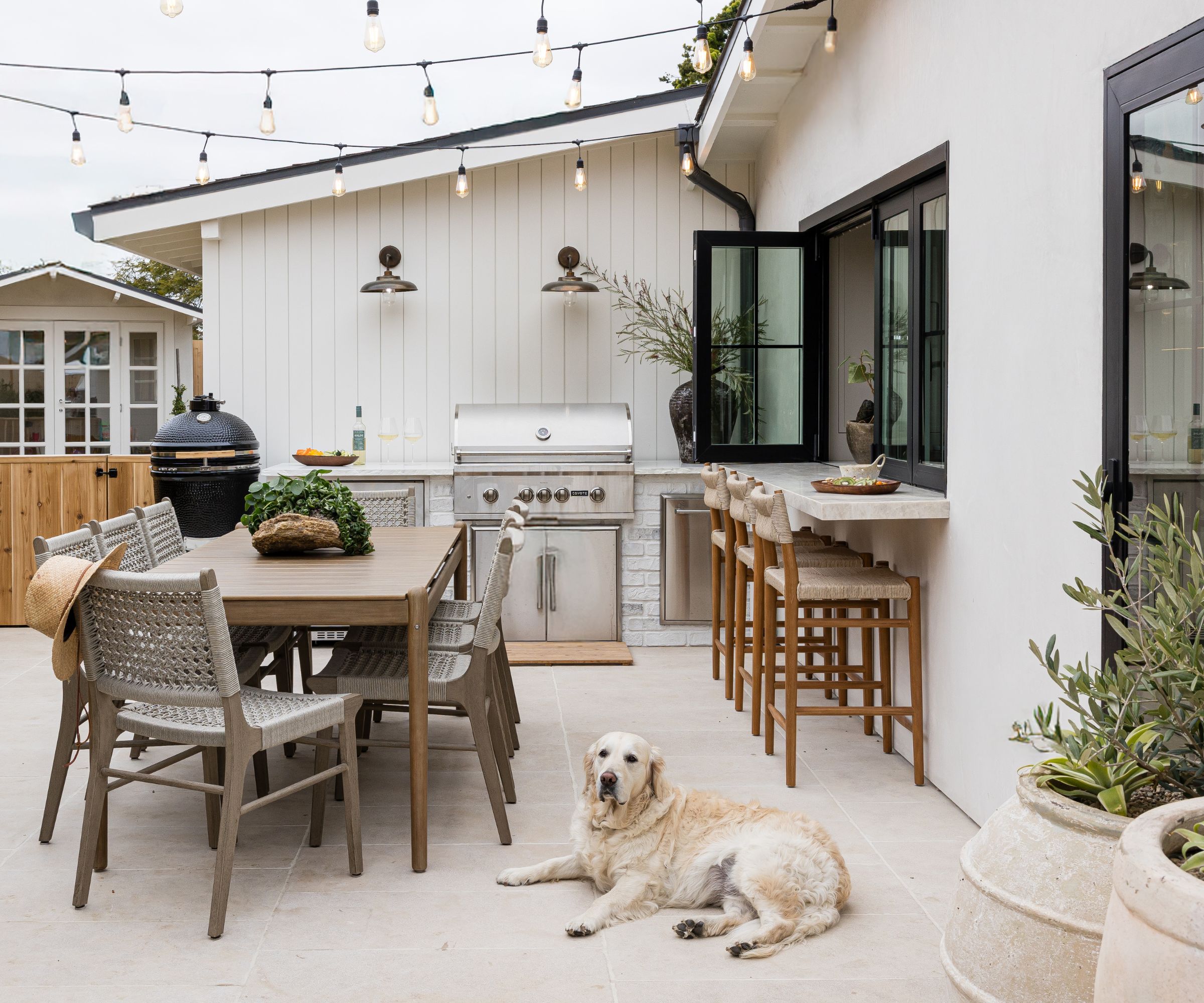Outdoor dining area with barbecue and kitchen hatch
