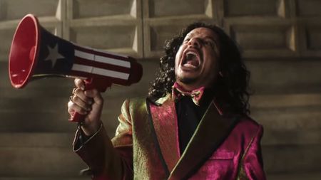 Don Sauvage hollering while holding a red, white and blue megaphone in Street Fighter (2026)