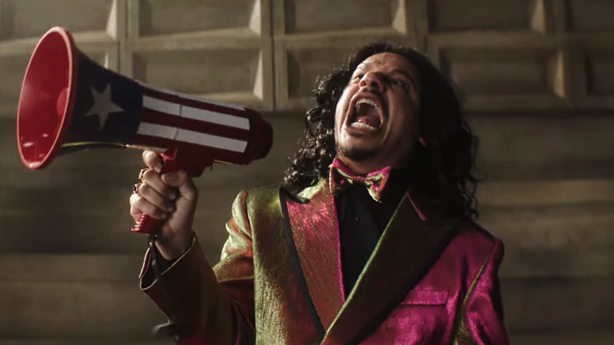 Don Sauvage hollering while holding a red, white and blue megaphone in Street Fighter (2026)
