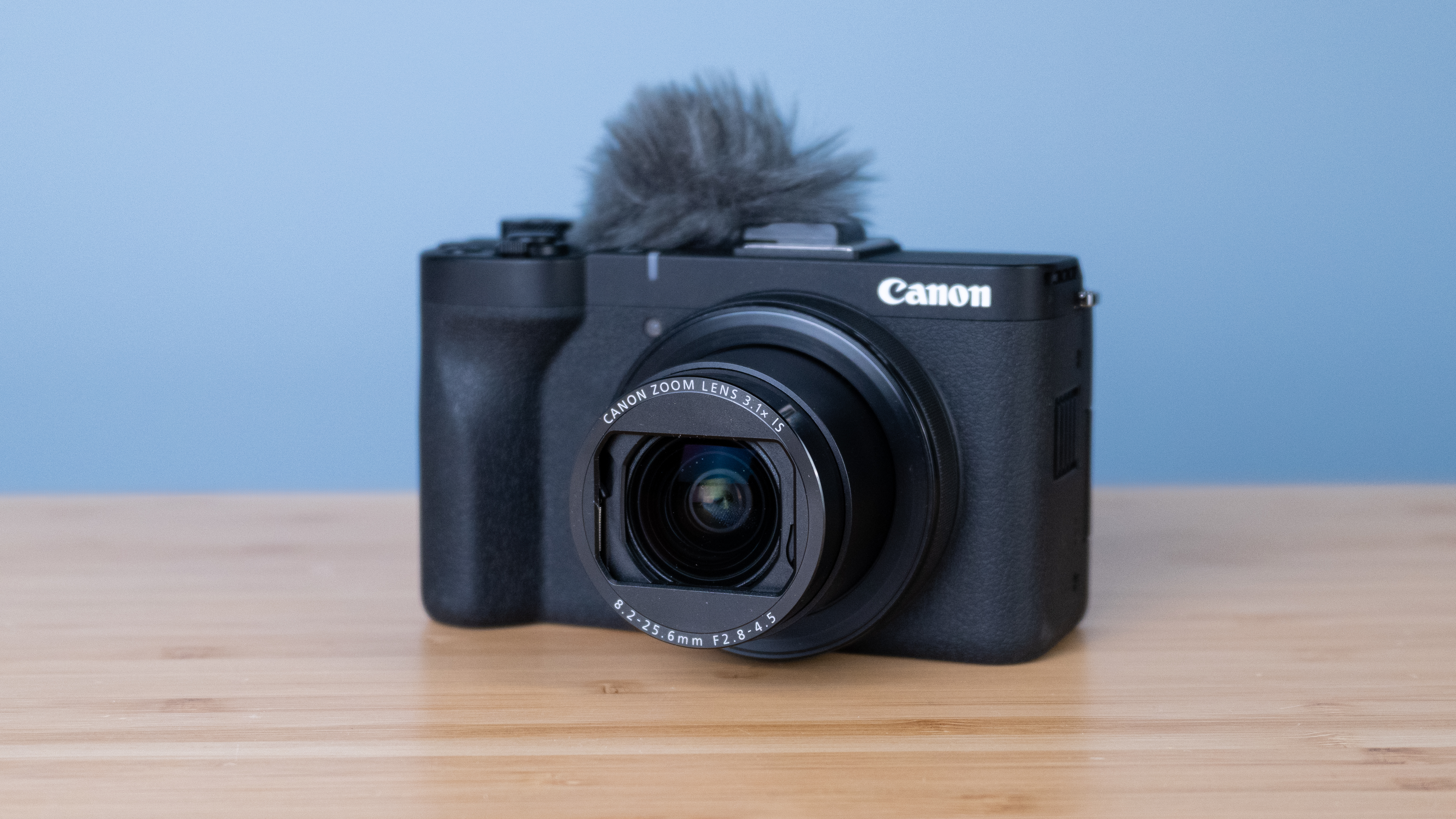 A black Canon PowerShot V1 compact vlogging camera