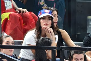 Kendall Jenner wears an olympics hat and a white t shirt at the paris olympics