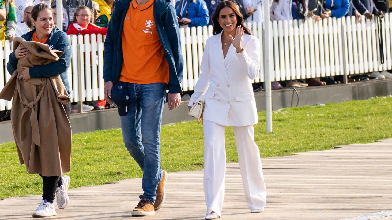 Meghan Markle waves and walks