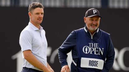 Justin Rose and caddie Mark 'Fooch' Fulcher look on at the 152nd Open Championship at Royal Troon