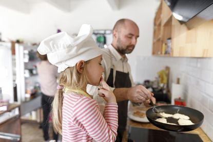 Father and daughter cooking in the kitchen for Pancake Day