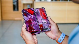 Pixel 9 Pro and Pixel 9 Pro XL held in the hand showing their displays.