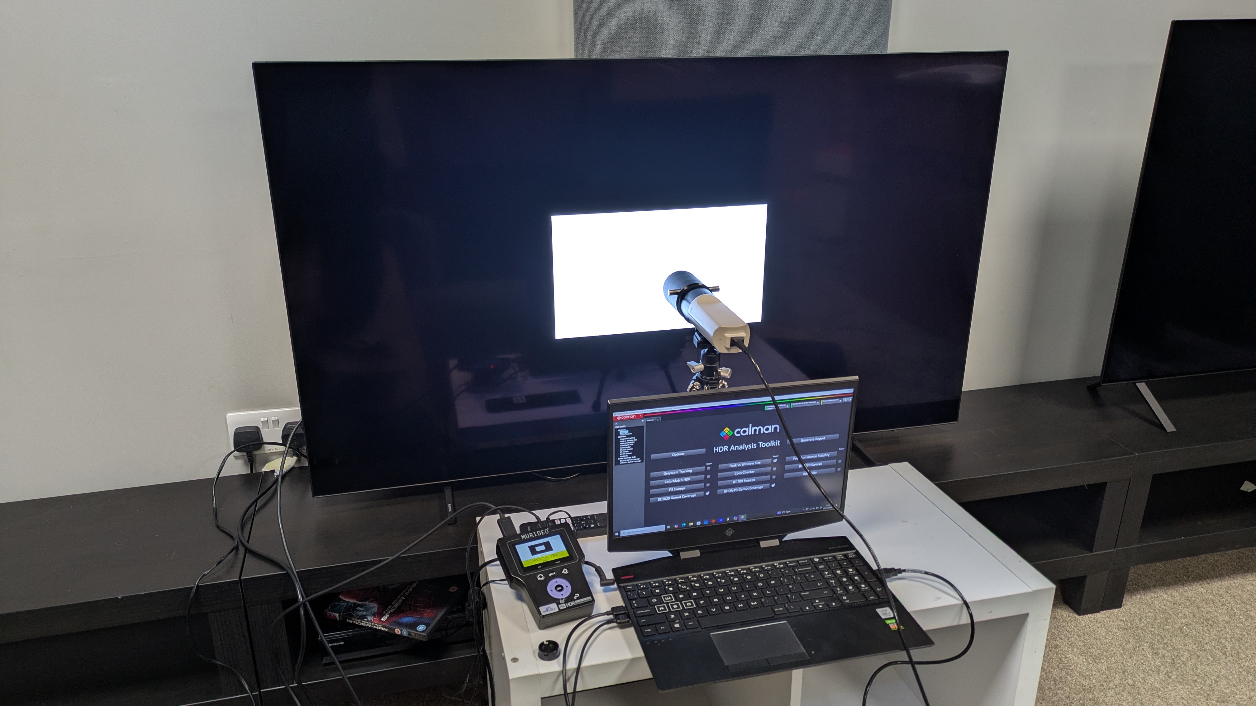 Philips OLED760 with testing equipment attached and white window test pattern on screen