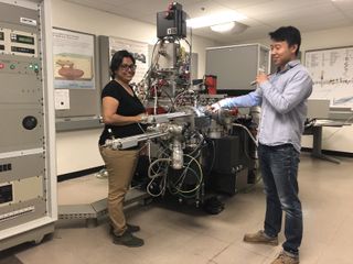 Cosmochemists Maitrayee Bose (left) and Ziliang Jin load samples of asteroid Itokawa into the high-vacuum chamber of the Nanoscale Secondary Ion Mass Spectrometer (NanoSIMS) instrument at Arizona State University.