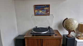 Audio-Technica AT-LP70XBT turntable, with the dust cover open, on a wooden table