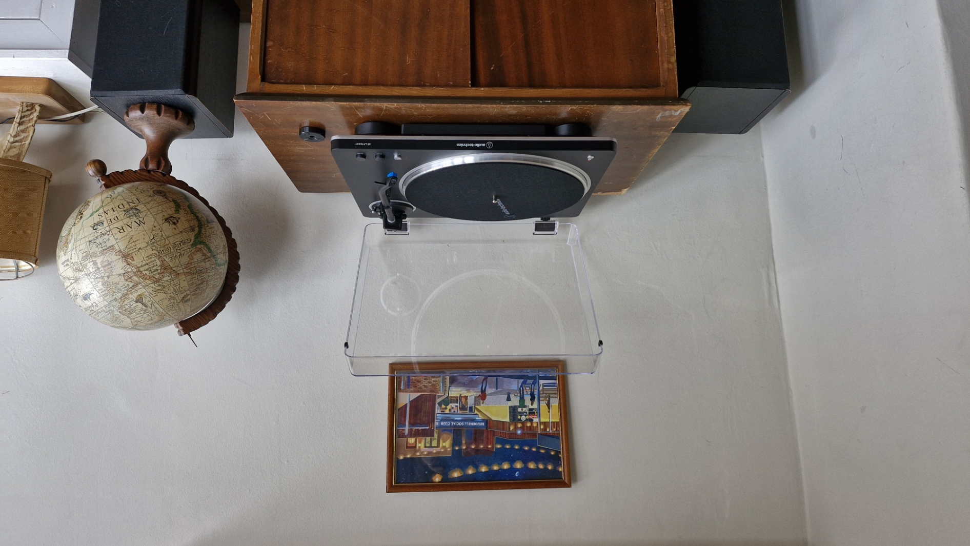 Audio-Technica AT-LP70XBT turntable, with the dust cover open, on a wooden table