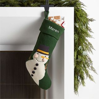 green christmas stocking with snowman