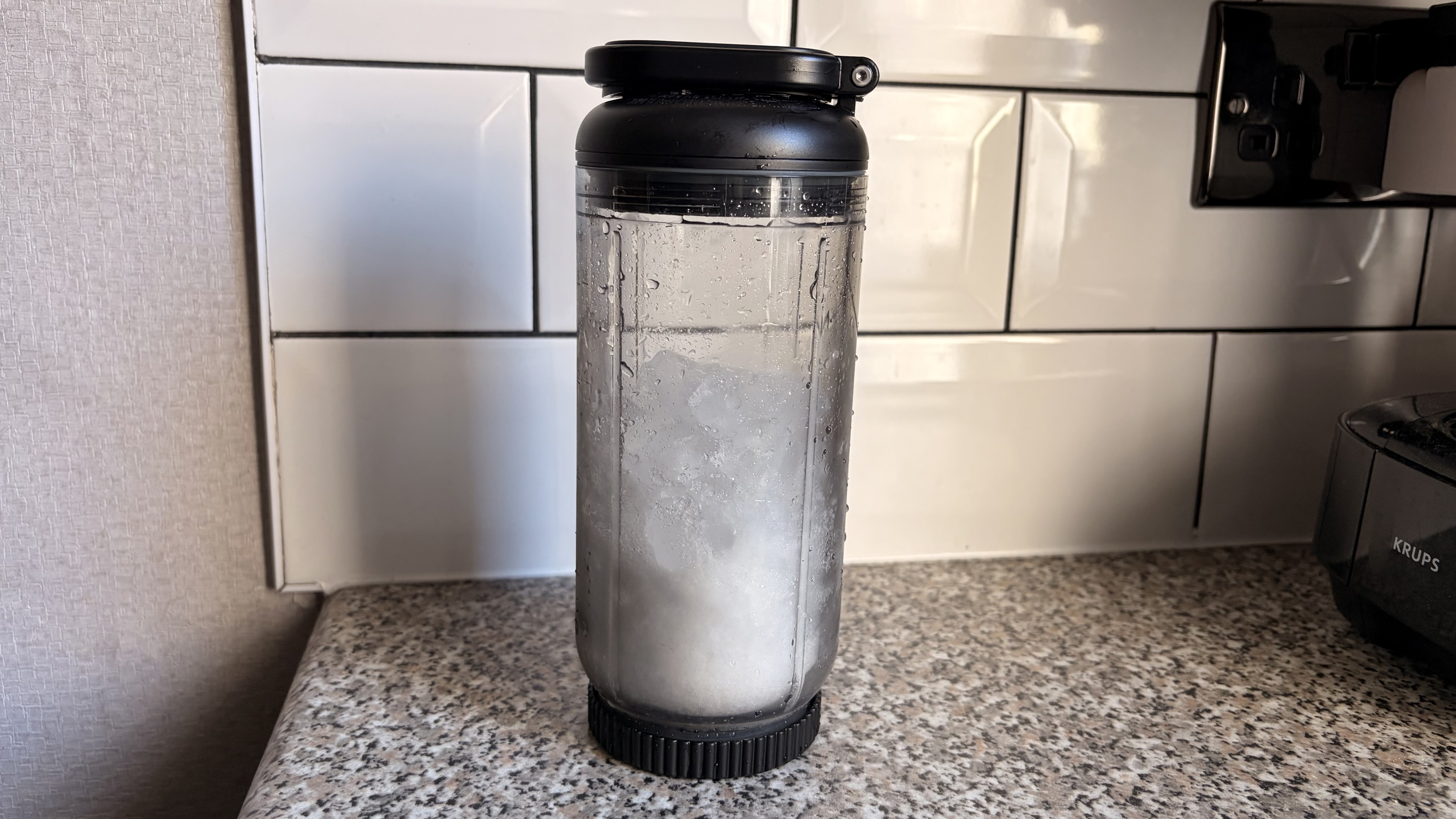 Ice crushed in the Nutribullet Flex blender photographed on a white background