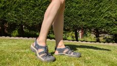 Feet modelling the Keen Newport H2 hiking sandals on the grass