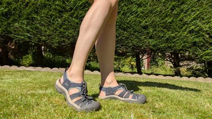Feet modelling the Keen Newport H2 hiking sandals on the grass