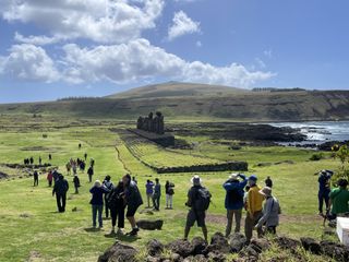 people walking around on easter island during an annular solar eclipse tour.