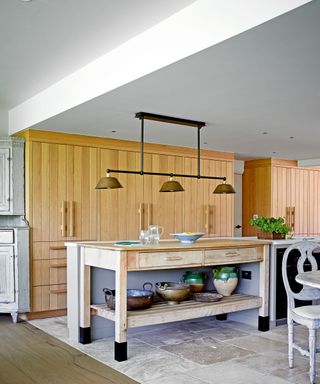 modern kitchen with wooden cabinetry, and island and lighting