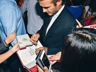 David Beckham signs books for fans in China