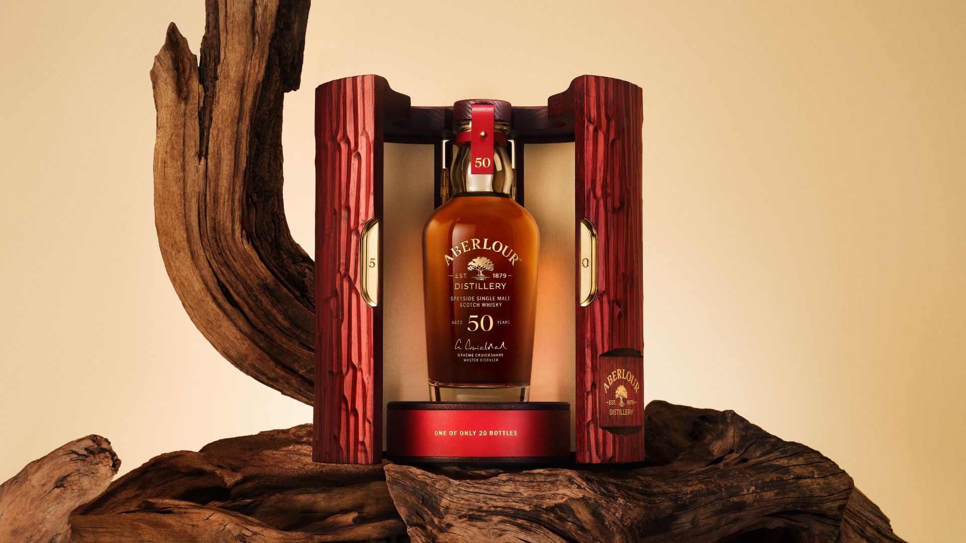 an image of the 50 year old bottle in the cabinet with the doors open against a wooden plinth