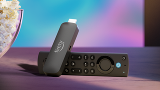 The Amazon Fire TV Stick 4K Max on a table next to popcorn