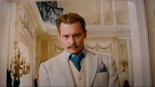 Johnny Depp in an ornate room with a slightly cocky expression in Mortdecai.