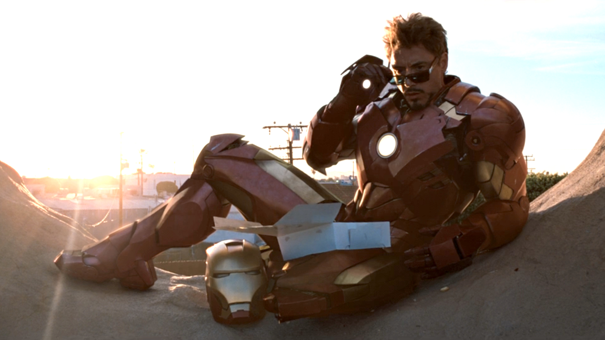 Tony Stark (Robert Downey Jr.) sits on a building in Iron Man 2.