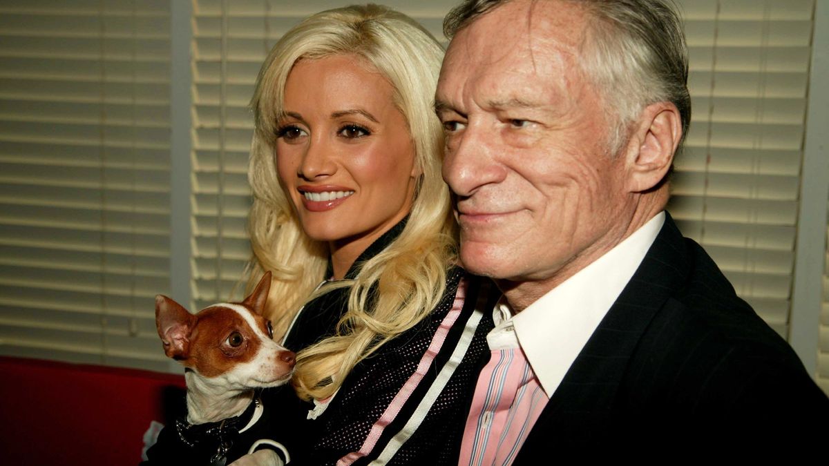 Hugh Hefner with ex-girlfriend Holly Madison who&#039;s holding her dog