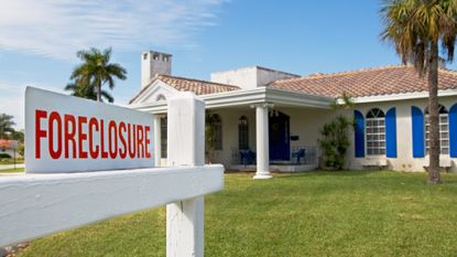 Foreclosure sign in front of a house