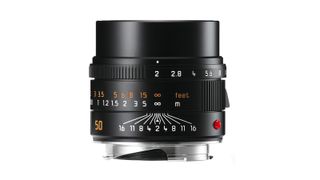 Product photograph of Leica Summicron-M f2 lens standing up vertically on white background, with focus distance scale showing