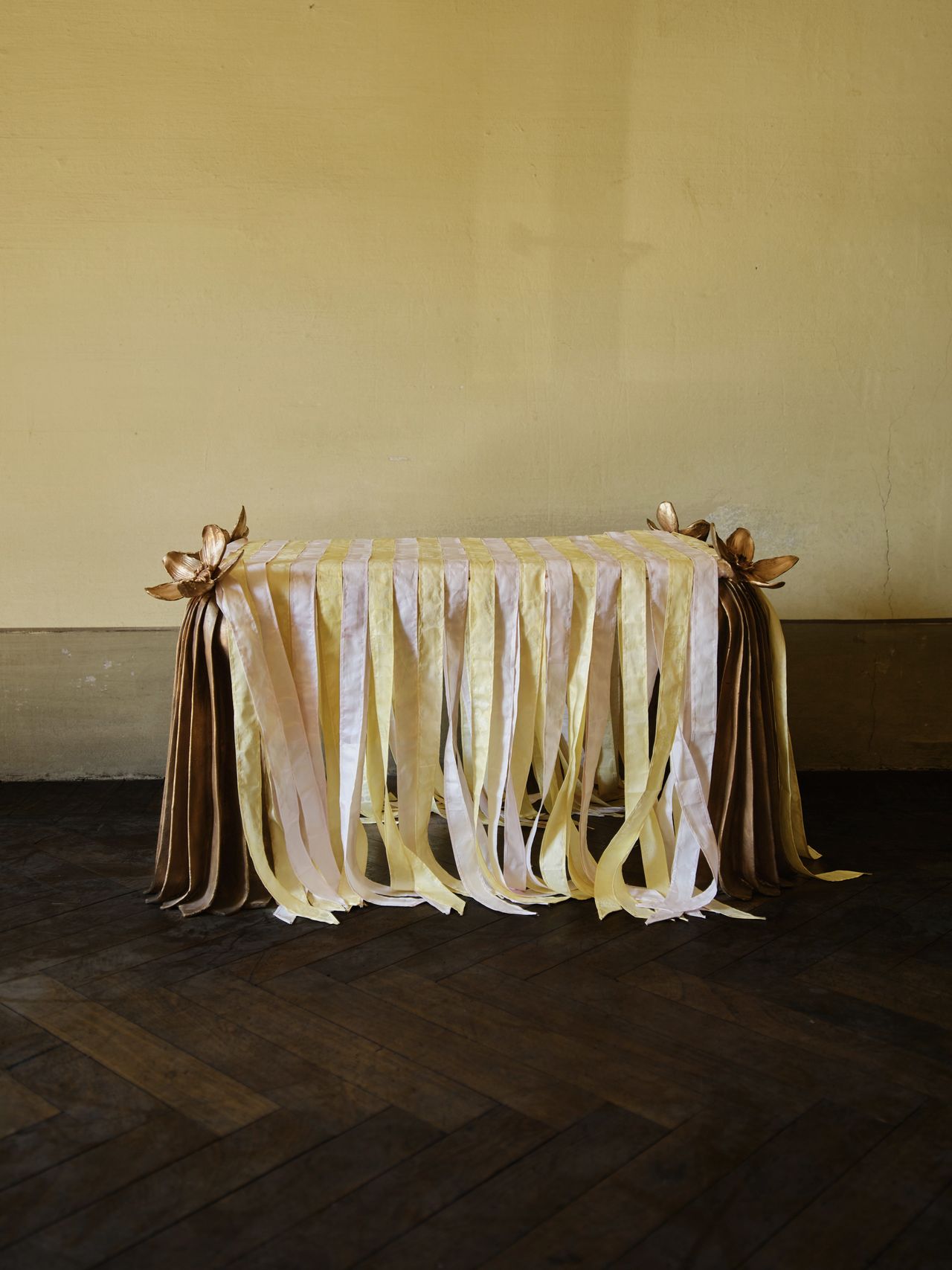 bronze furniture draped in pastel ribbons