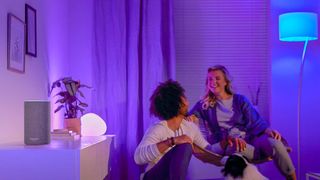 People in a room lit with Philips Hue lights