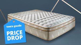 Image shows the Saatva Classic luxury innerspring hybrid mattress on a dark blue background with gold accents, with a light blue Tom's Guide price drop sales badge overlaid in the bottom left hand corner