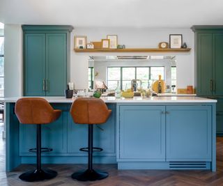 blue based kitchen island with seating area plus cupboards in base