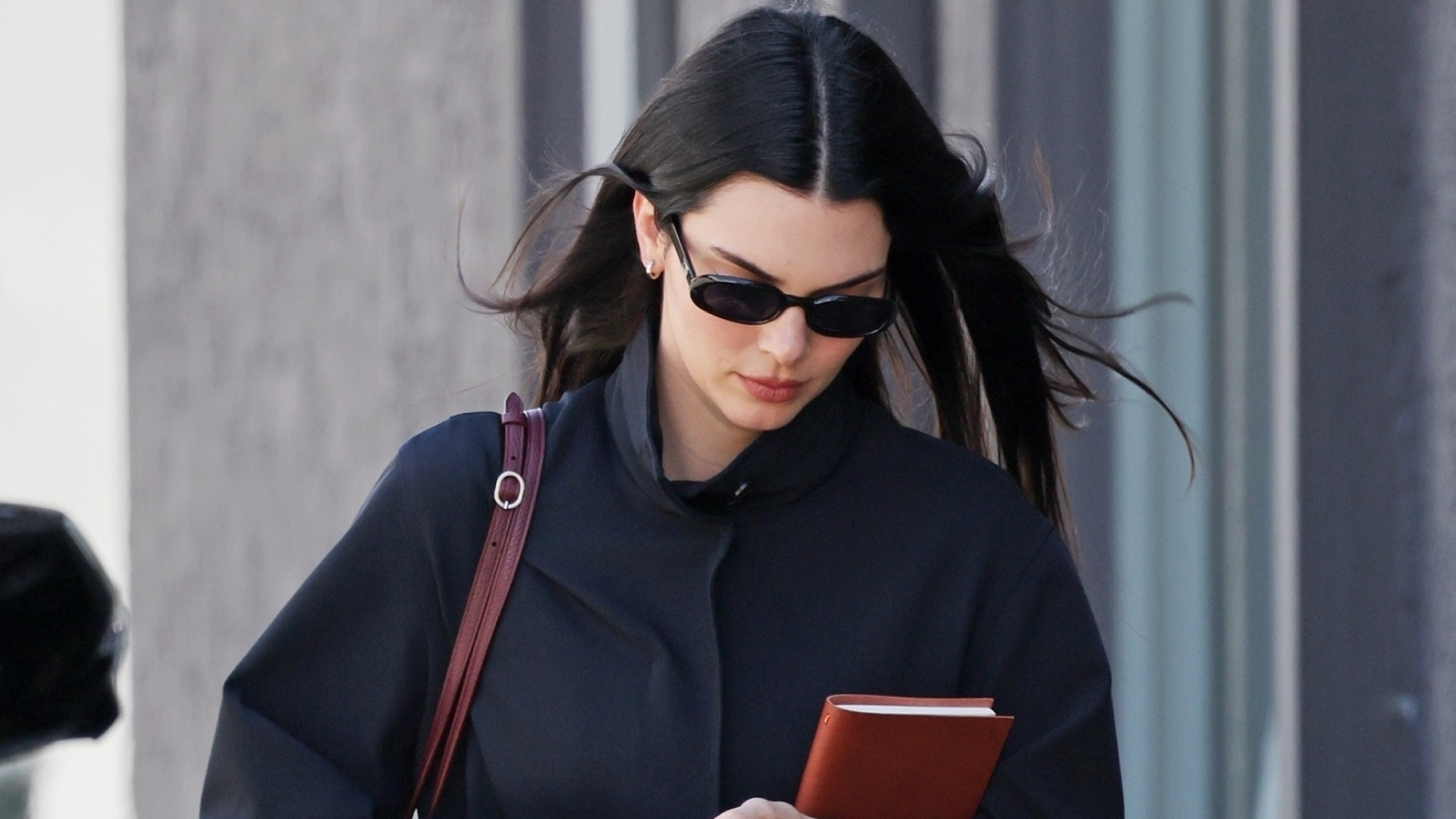 Kendall Jenner wore the high-vamp flats trend and straight-leg jeans with a burgundy and navy color combination