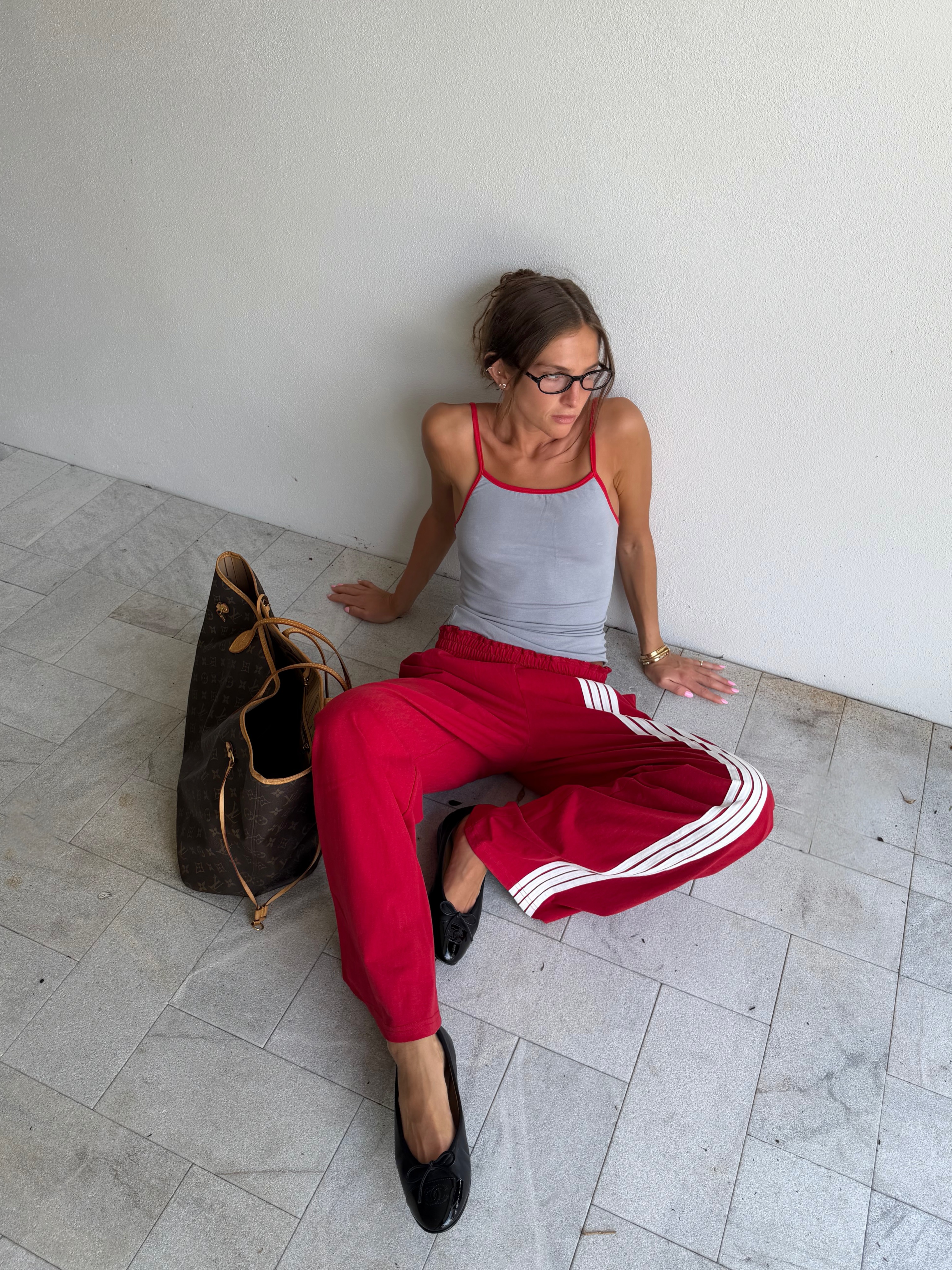 Woman in track pants and ballet flats.
