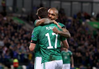 Josh Magennis, right, congratulates Paddy McNair after his corner led to Benas Satkus' own goal