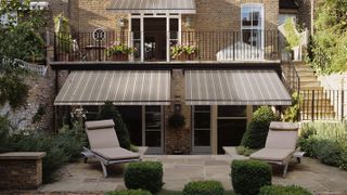 small patio with double awning over patio doors