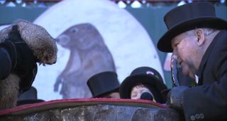 Official groundhog handler Bill Deeley speaks "groundhogese" to communicate with Punxsutawney Phil on Feb. 2, 2017, in Punxsutawney, Pennsylvania.