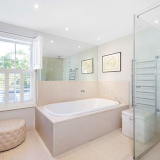 bathroom with shower and white window