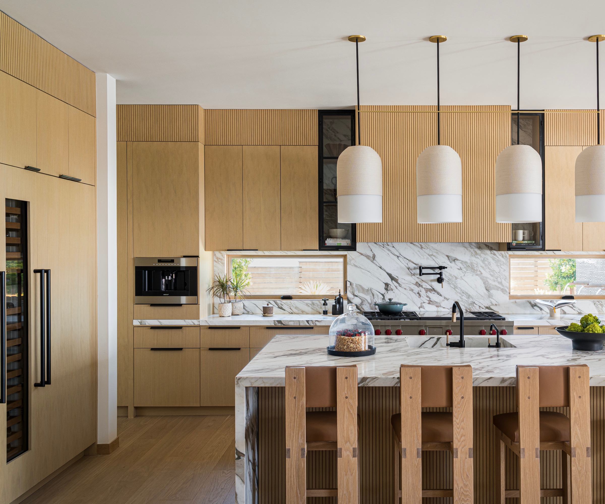 A large kitchen with solid wood cabinets and marble countertops