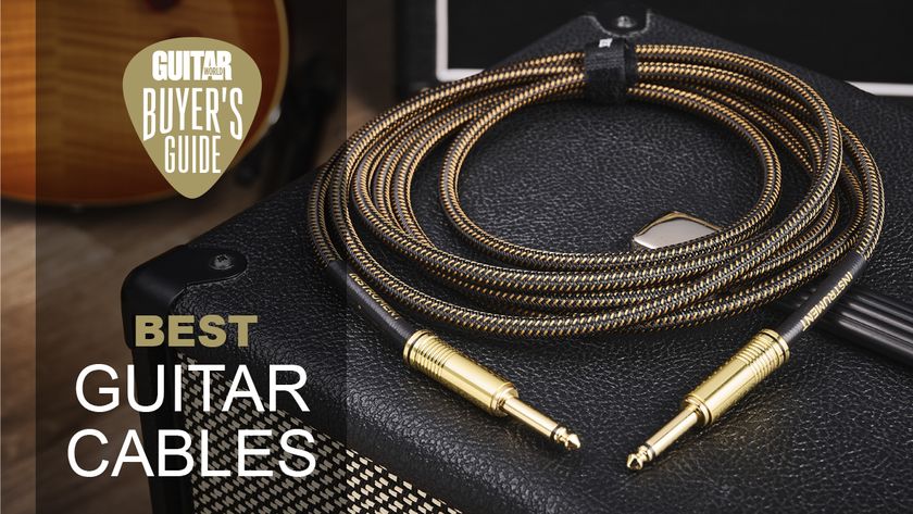 A black and gold guitar cable lying on top of an amplifier