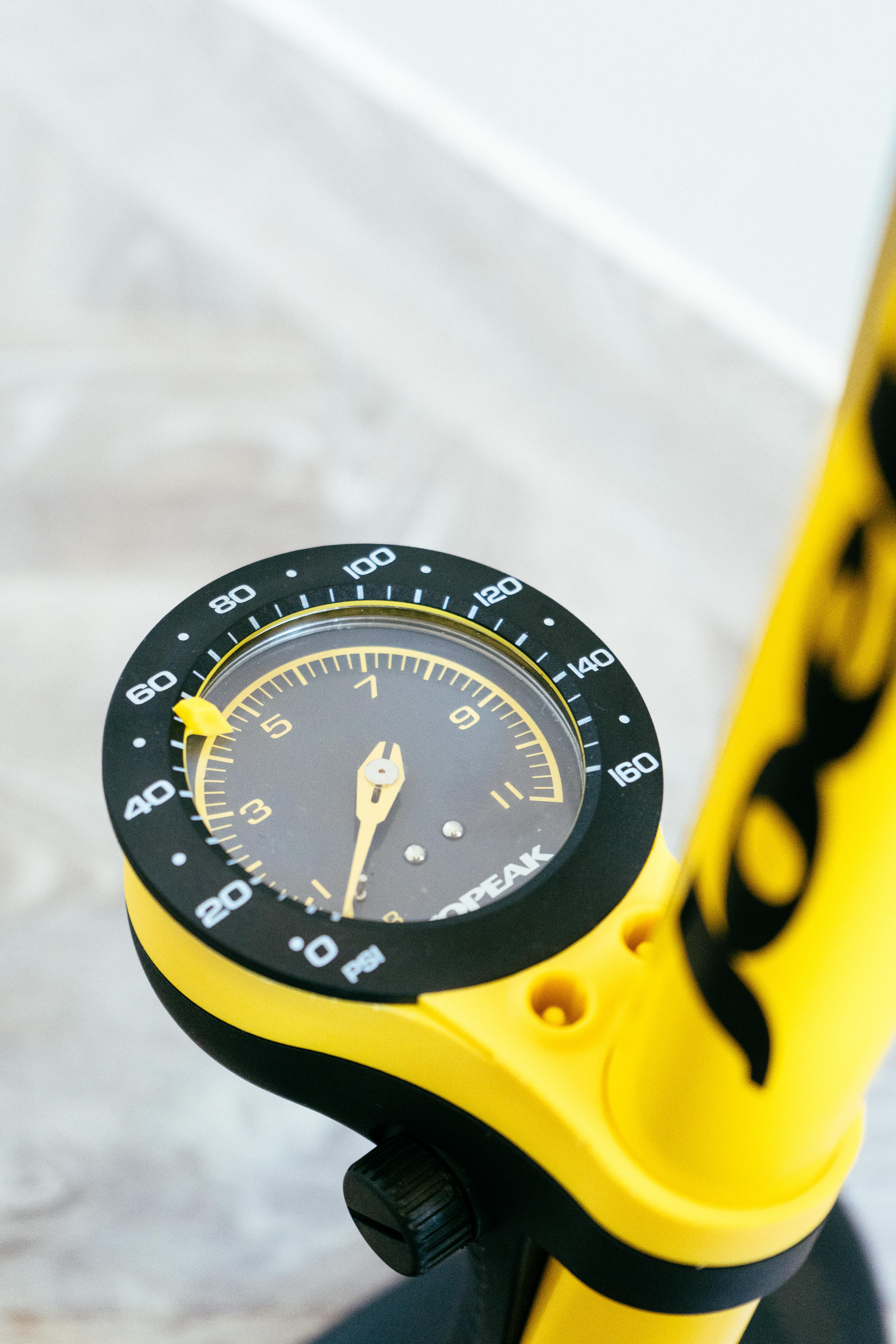 a close up of the yellow dial of a floor pump