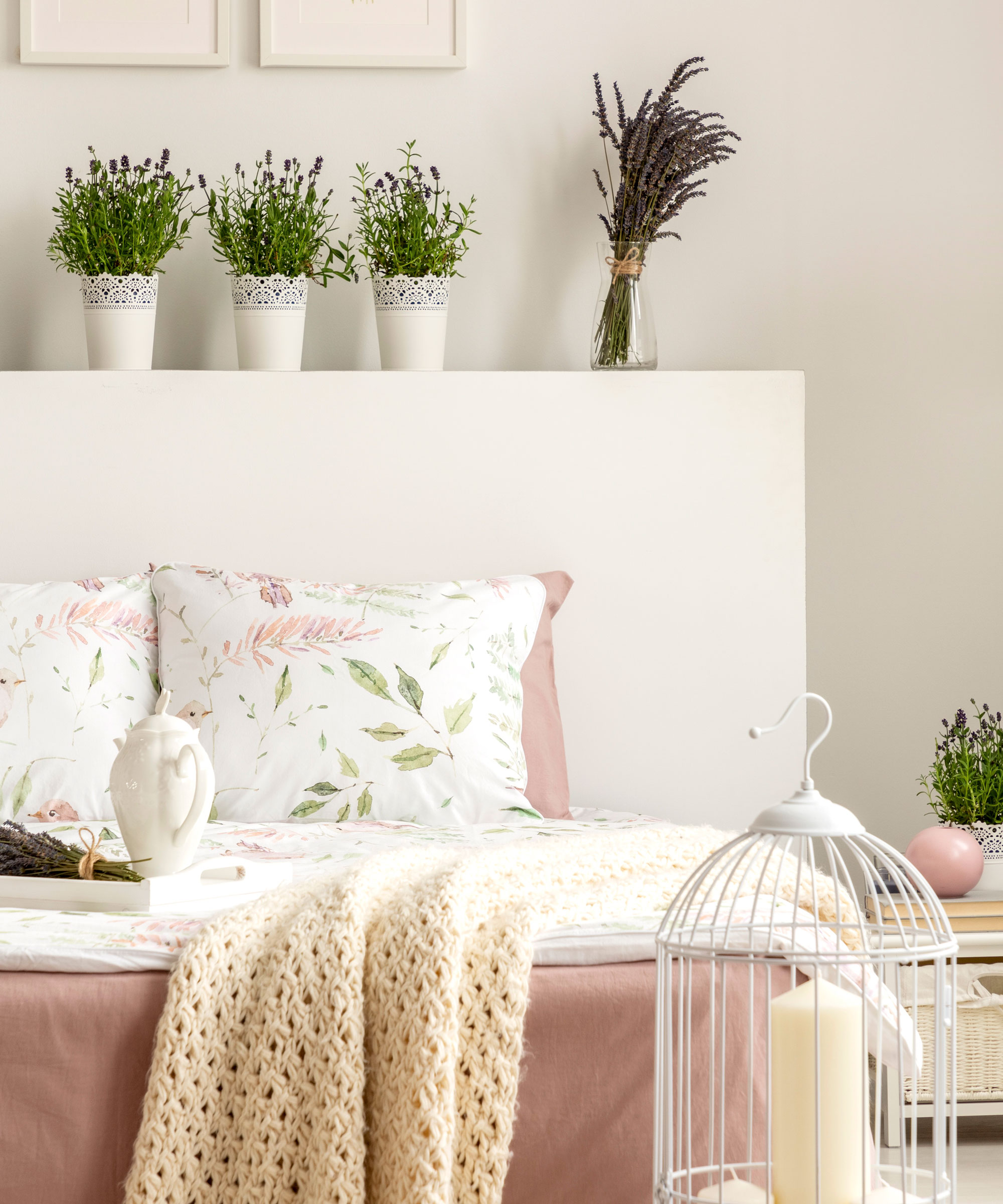 lavender plants in white bedroom with soft furnishings