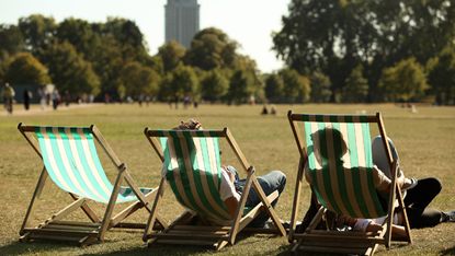 LONDON, ENGLAND - SEPTEMBER 08:Members of the public recline in deckchairs as they enjoy the afternoon sunshine in Hyde Park on September 8, 2009 in London, England. Temperatures in the capit