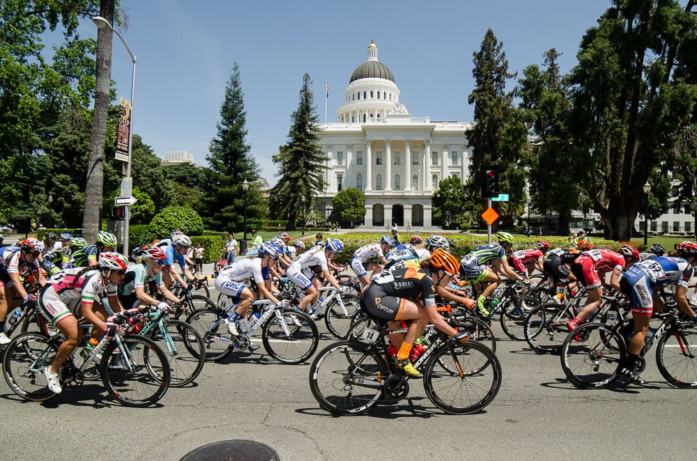 Riders pass by the capitol in Sacramento