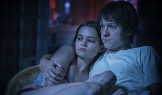 Ciara Bravo and Tom Holland getting close on the couch in Cherry