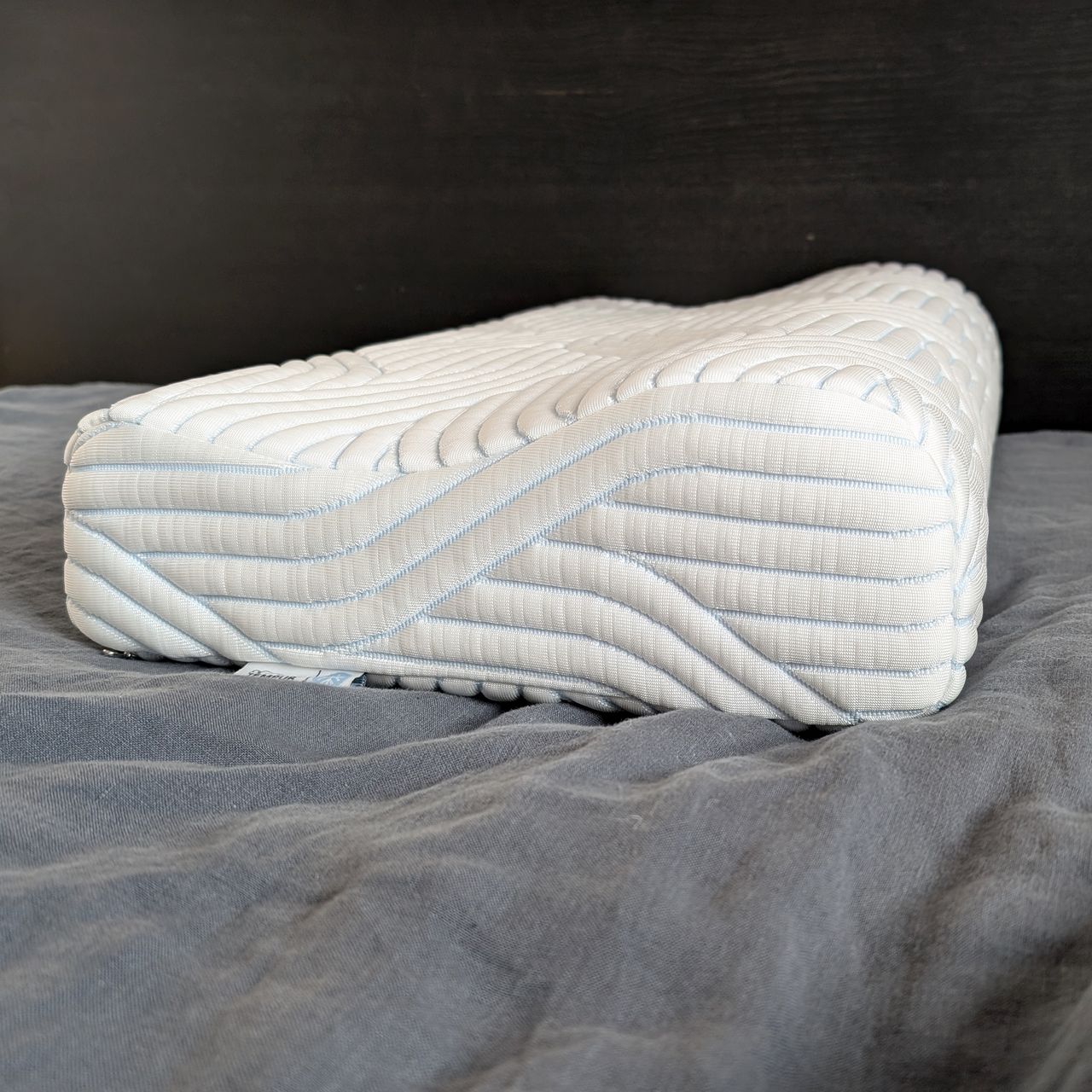 The Tempur Original SmartCool Pillow with raised curved edge on the right and a lower side on the left.