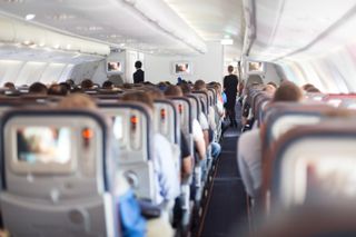 Passengers seated inside an airplane.