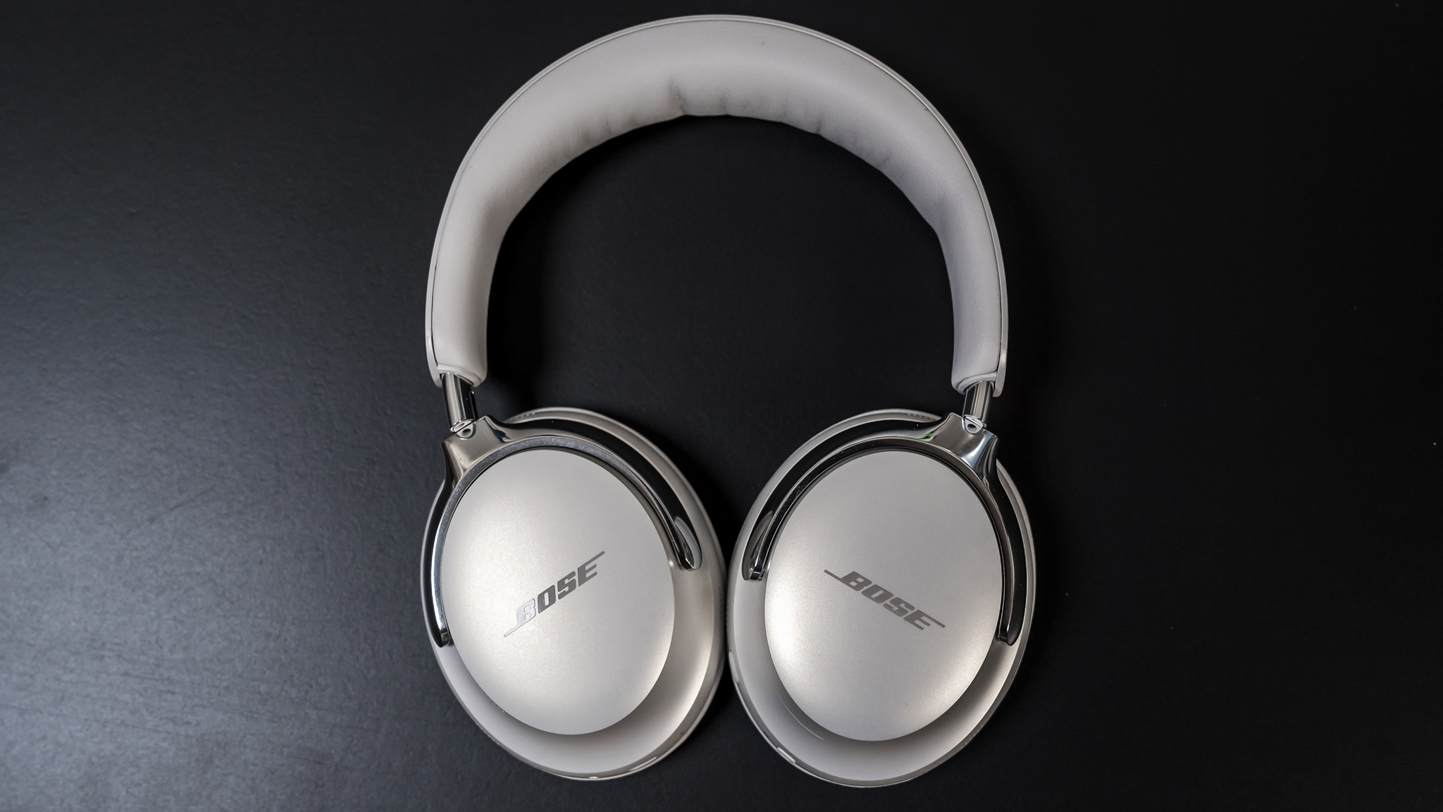 Bose QuietComfort Ultra headphones laying flat.