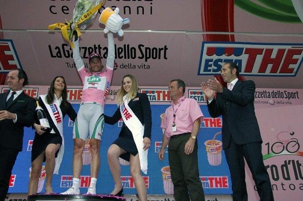 Alessandro Petacchi (LPR Brakes-Farnese Vini) celebrates on the podium while Bernard Hinault looks on.