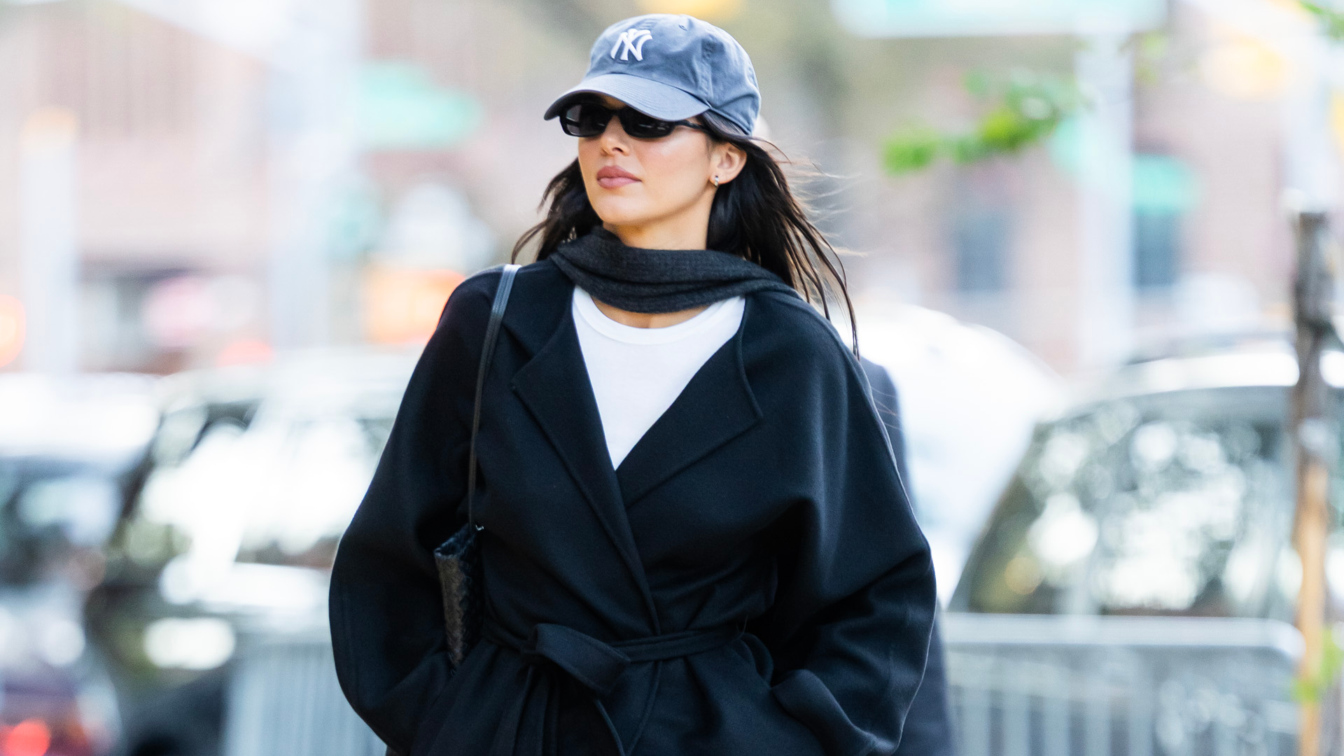 Kendall Jenner was spotted in NYC wearing an incredibly shoppable outfit: bootcut jeans, a black wrap coat, and pointy boots